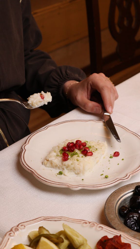 A dish of traditional Turkish dessert garnished with pomegranate and pistachios, in Gaziantep.