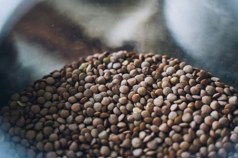 A focused shot of organic lentils inside a glass jar, showcasing texture and detail.