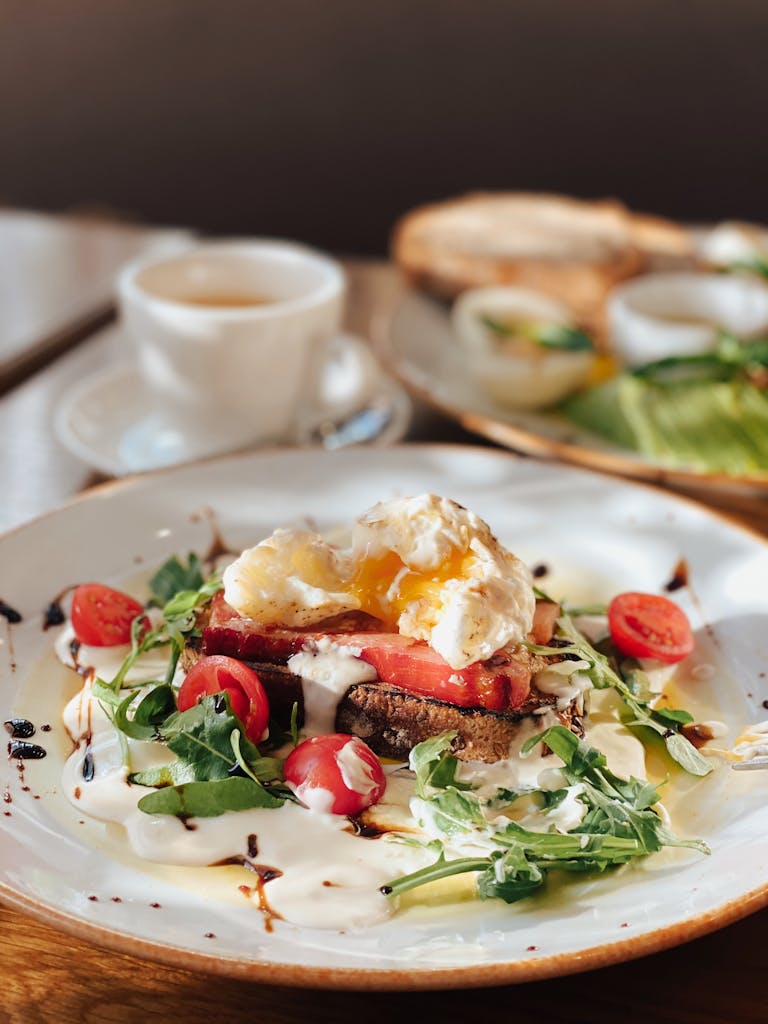 Delicious breakfast dish featuring a poached egg, arugula, and cherry tomatoes.