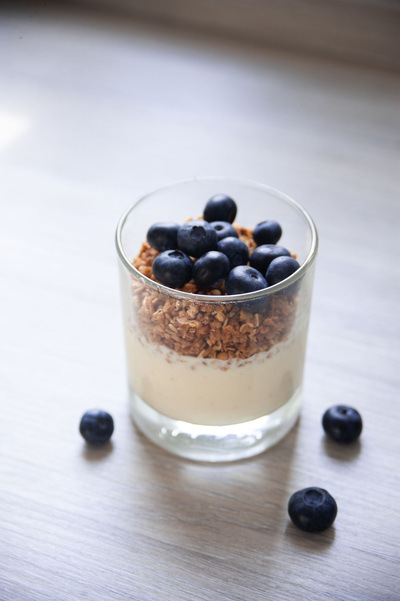 Delicious yogurt parfait with blueberries and granola in a glass, perfect for a healthy breakfast.