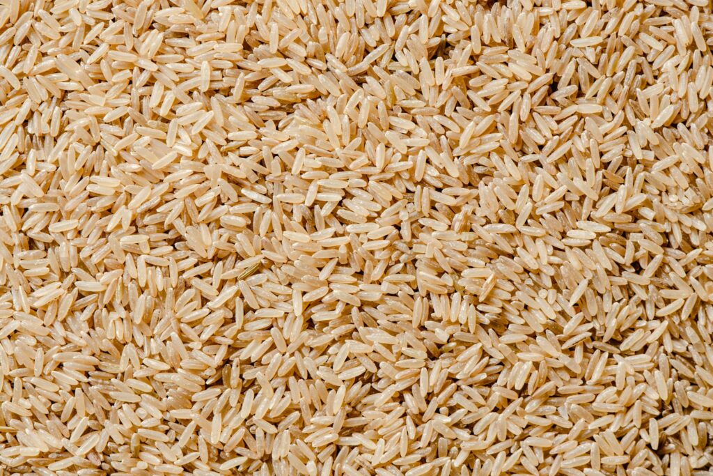 High-resolution close-up of uncooked brown rice showcasing its natural texture and color.