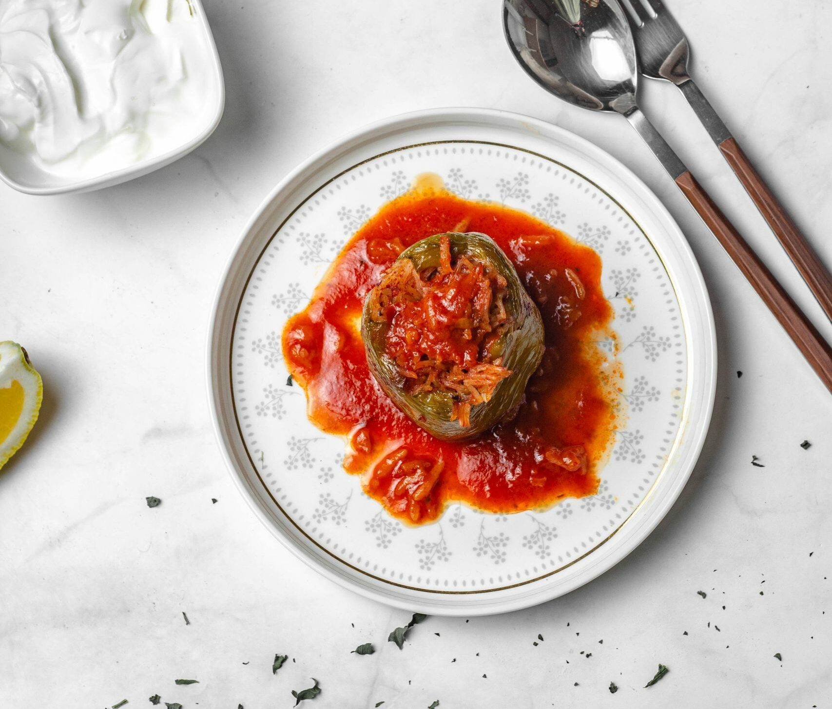 Savor the flavor of stuffed bell peppers served with rich tomato sauce. Perfect for a hearty meal.