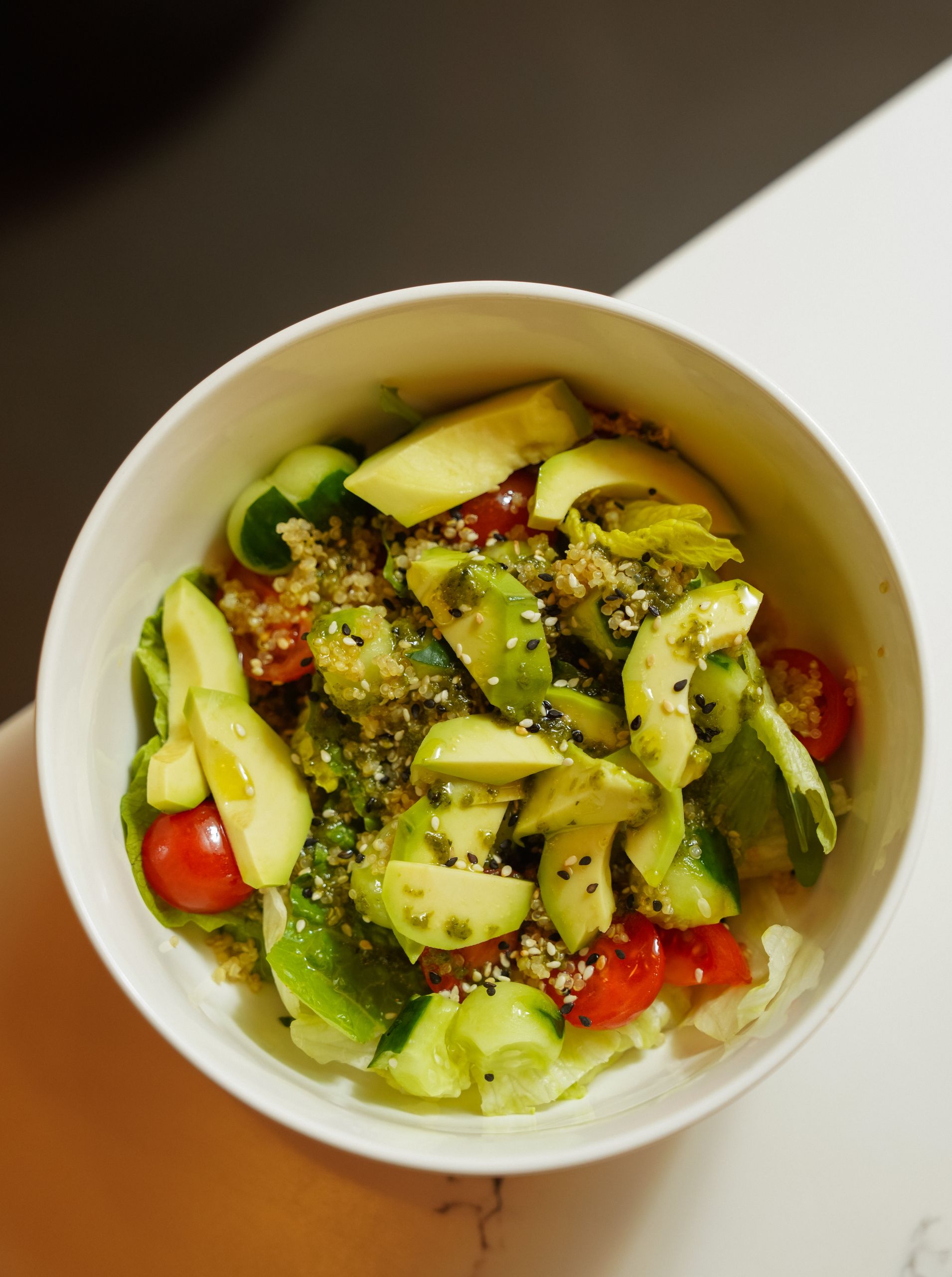 Vibrant quinoa salad topped with fresh avocado, cherry tomatoes, and mixed greens.