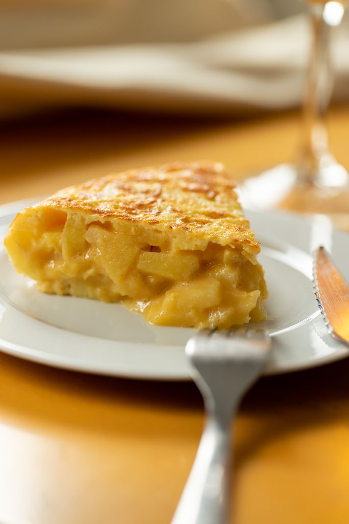A delicious slice of homemade apple pie served on a white plate, ready to enjoy.