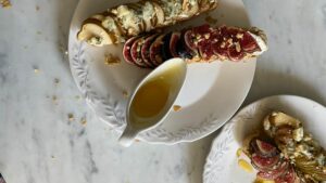 Gourmet tartines with figs, blue cheese, and nuts on marble, perfect for a classy breakfast.