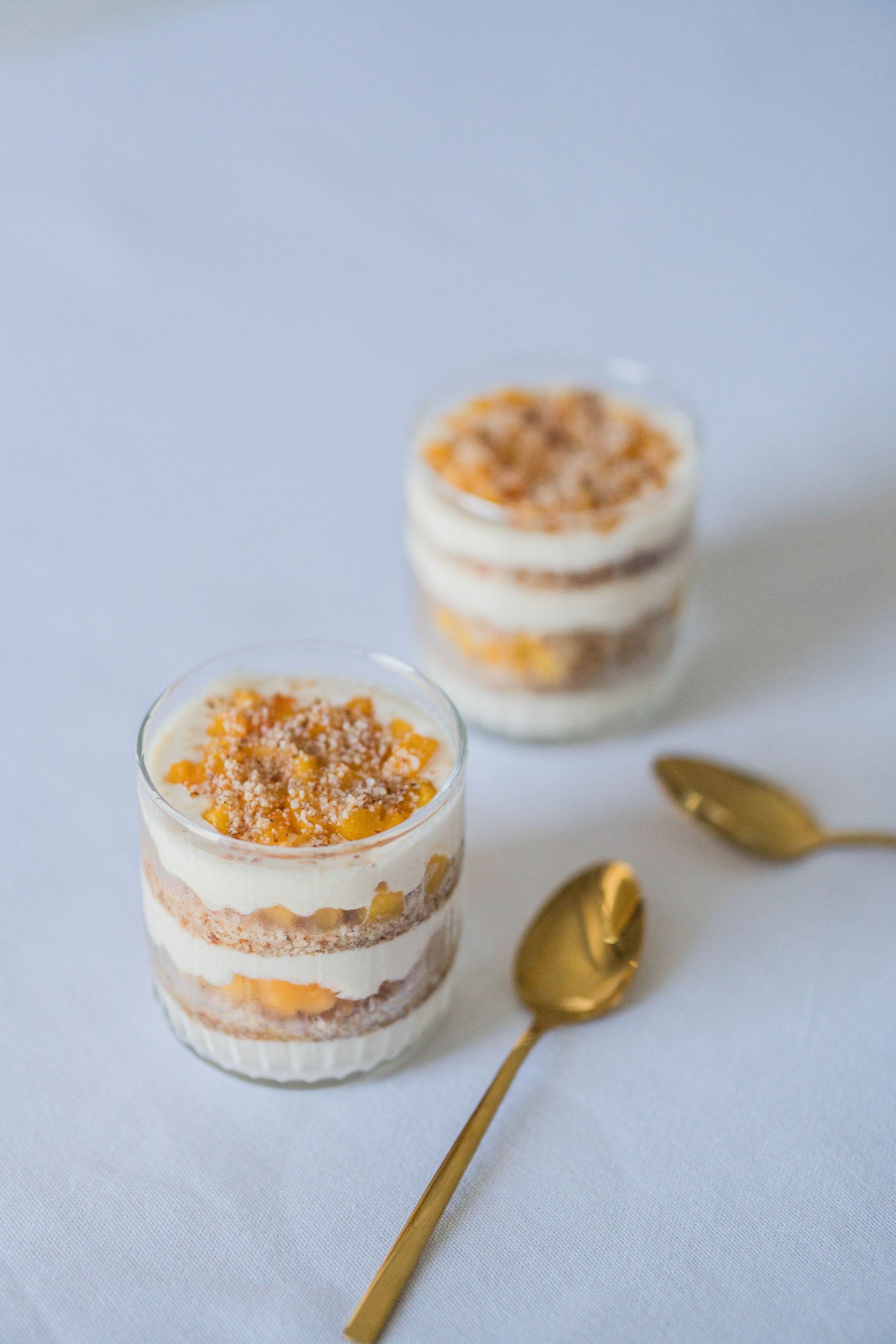 Layered dessert with cream and caramel in glass jars, perfect for a sweet treat.