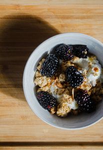 Top view of a nutritious breakfast bowl with blackberries and granola, perfect for a healthy start.