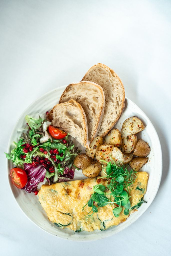 A delicious and nutritious breakfast with omelette, salad, and bread, perfect for a healthy start.