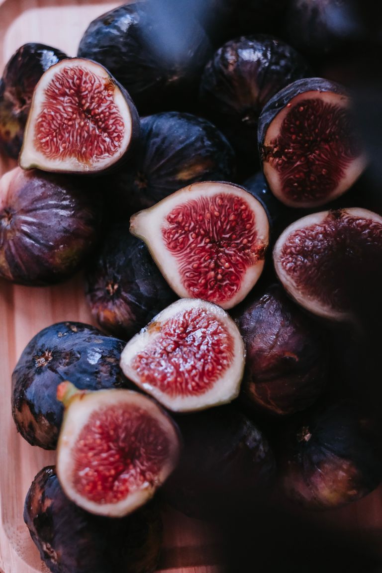 A detailed close-up of ripe figs sliced open, showcasing their textures and colors.