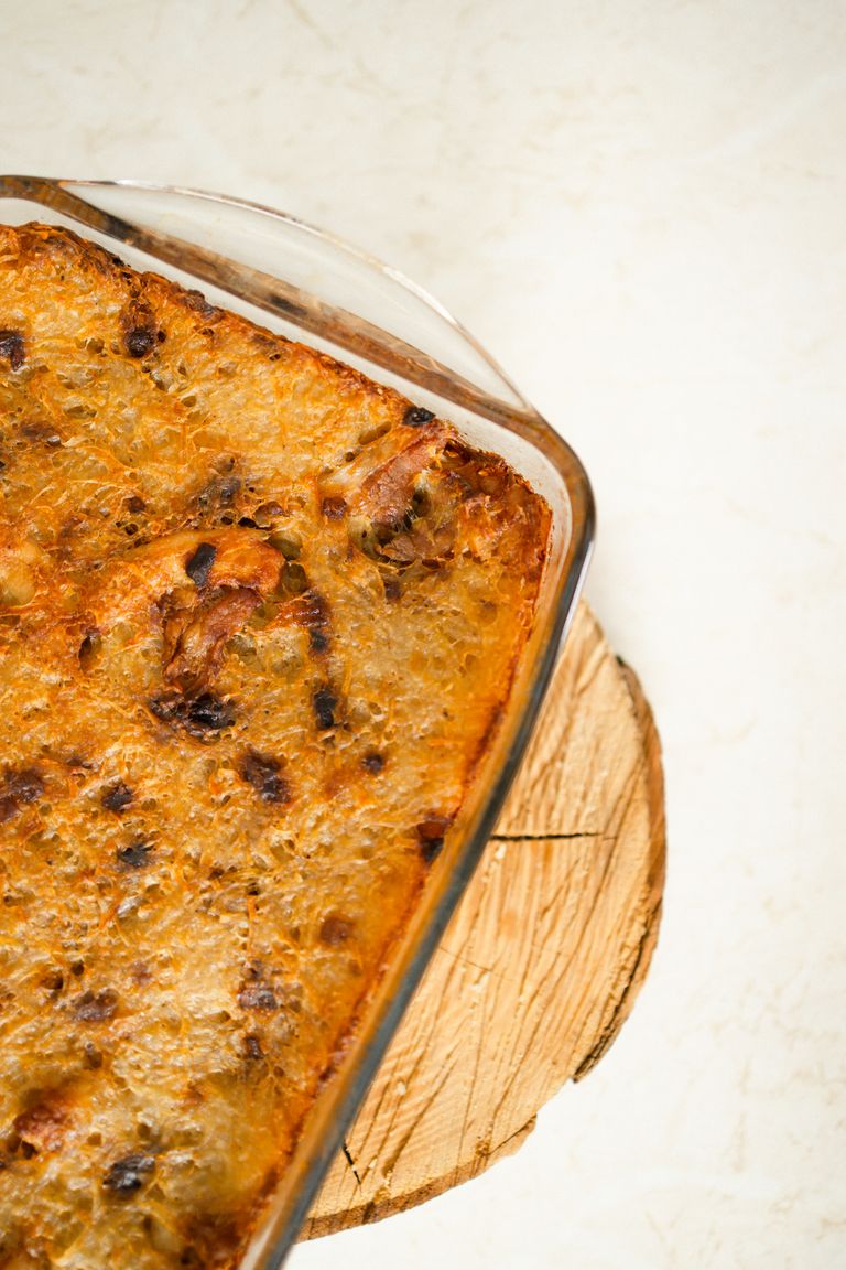 Crispy baked pastry in a glass dish on a wooden board, perfect for any meal.
