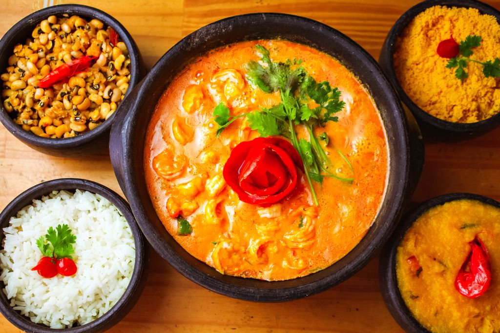 Delicious Indian curry with rice and side dishes, garnished with herbs, perfect for a flavorful dinner.