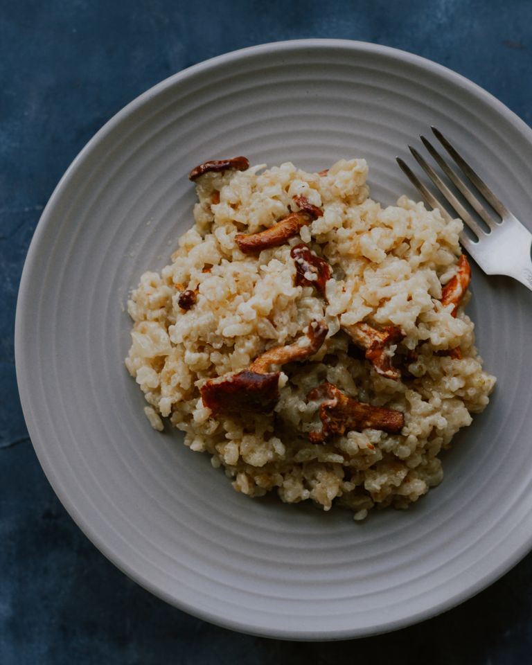Delicious mushroom risotto served on a gray plate, perfect for a cozy meal.