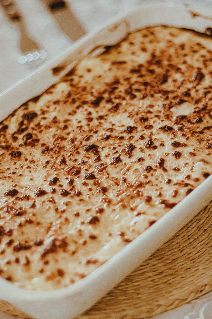 Deliciously baked cheese dish in a ceramic container, perfect for meals.