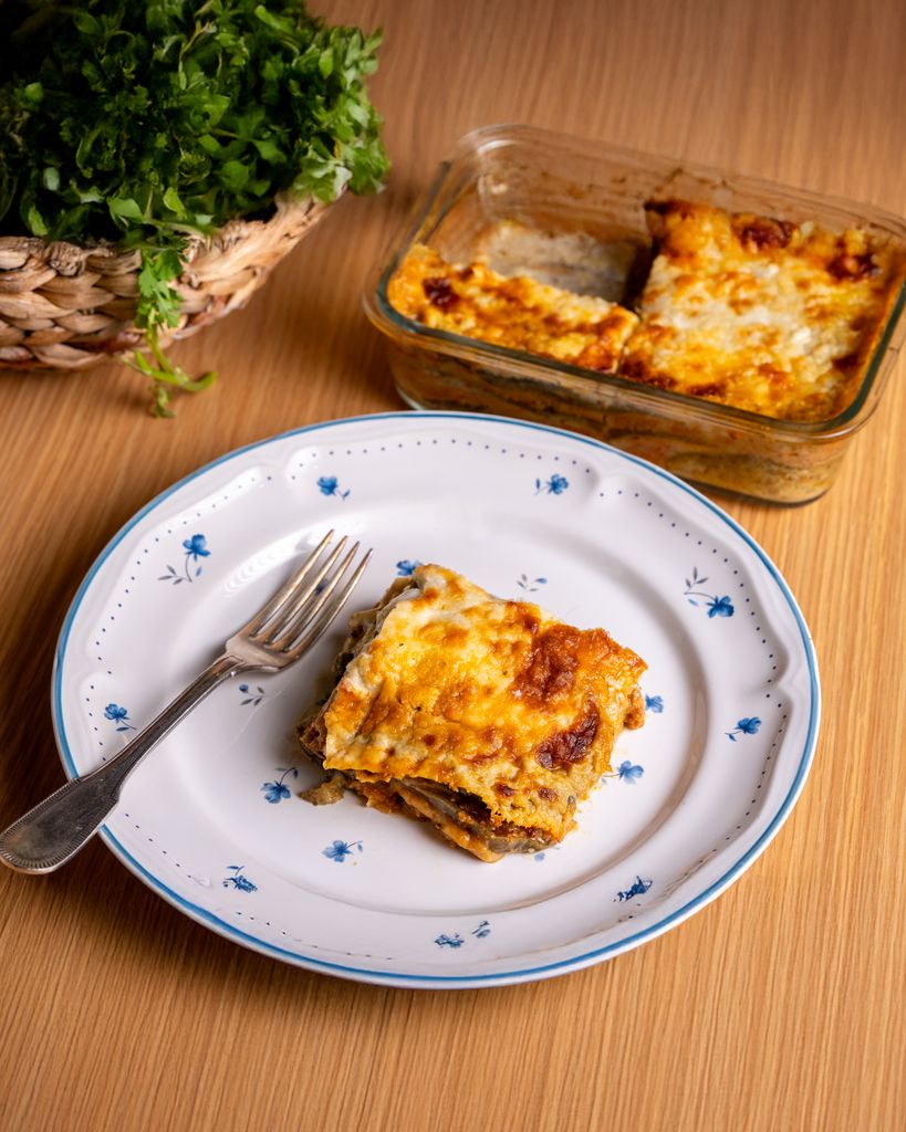 Tasty homemade lasagna served with fresh herbs, perfect for dinner.