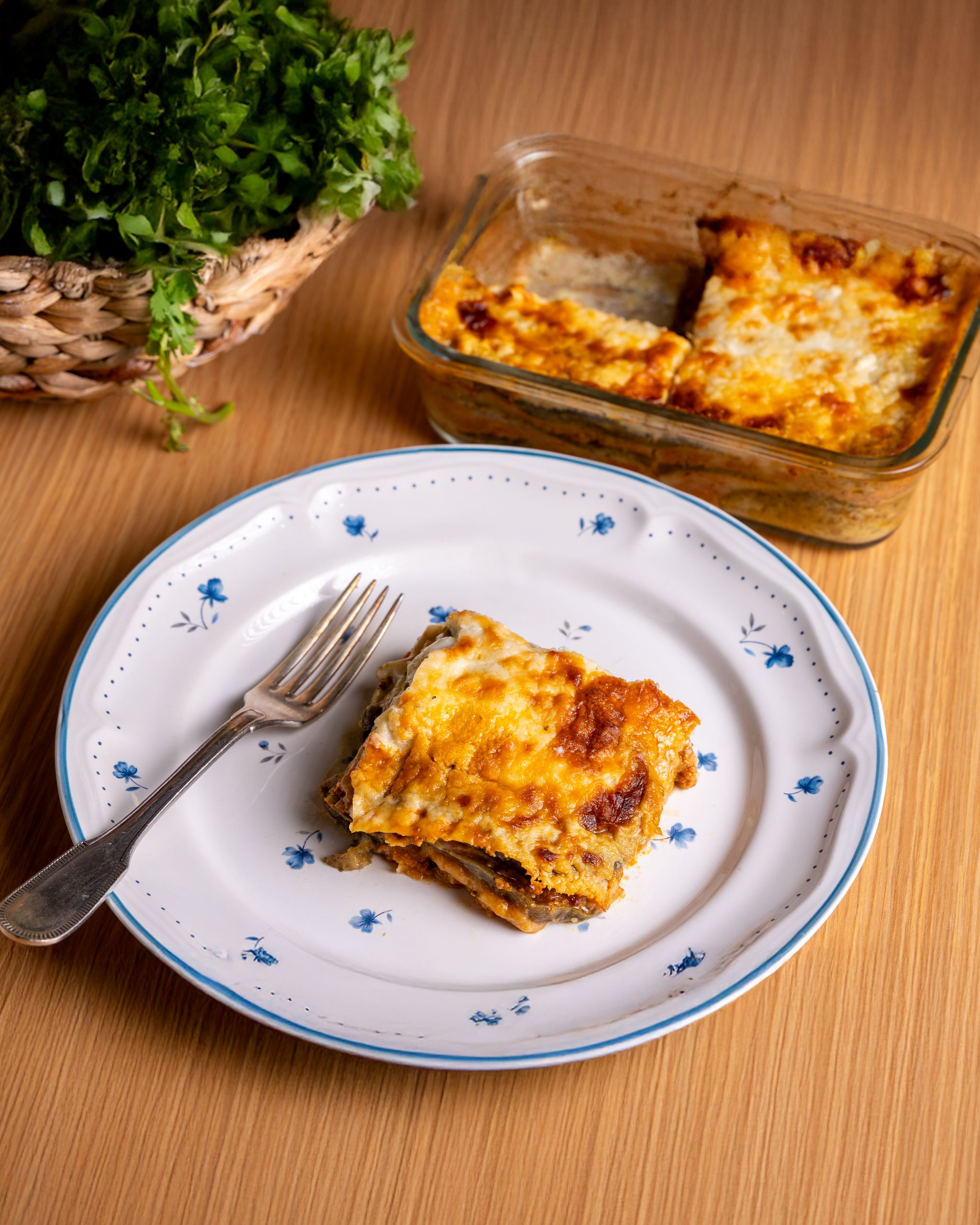 Tasty homemade lasagna served with fresh herbs, perfect for dinner.