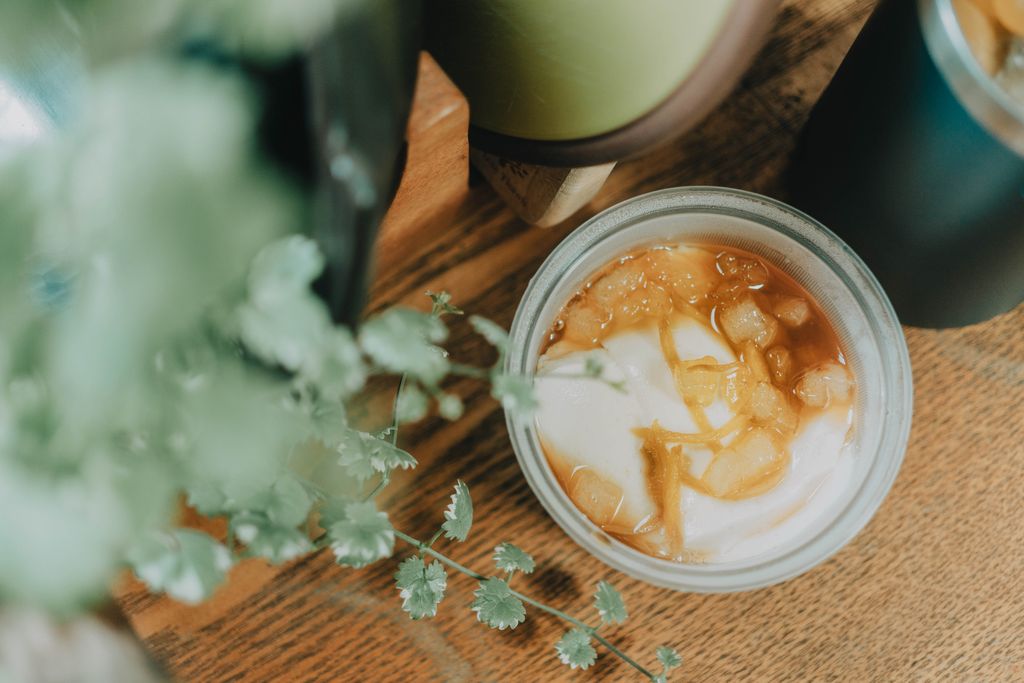 Top view of a refreshing iced beverage with mint leaves on a wooden table, perfect for summer.