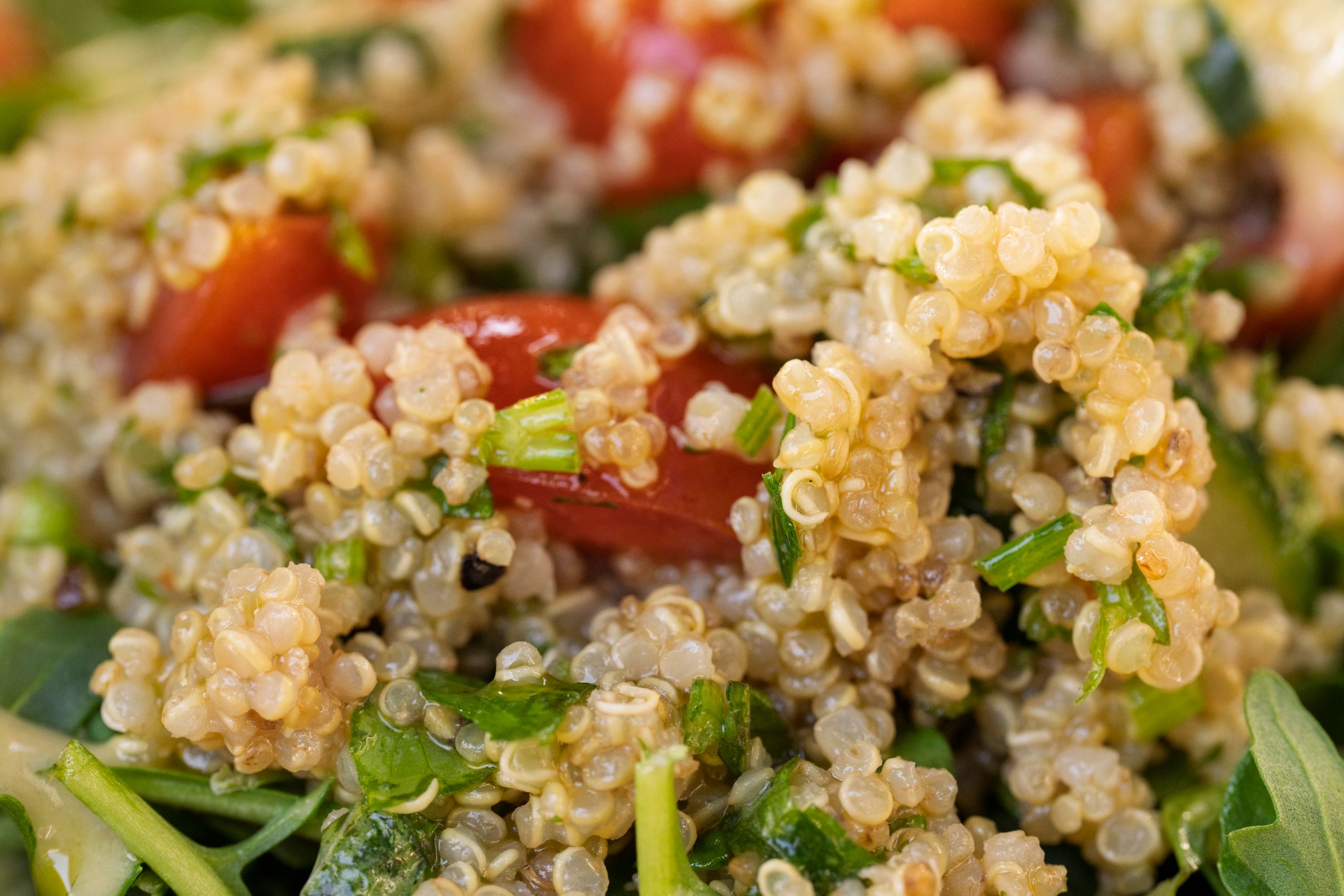 Vibrant quinoa salad with cherry tomatoes, greens, perfect for healthy eating.